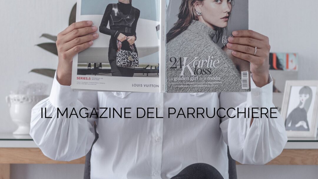 Donna in camicia bianca legge una rivista di moda con la copertina aperta, con il testo sovrapposto "Il Magazine del Parrucchiere".