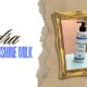 Immagine promozionale di Hydra Nutrishine Milk di Vision Products, un latte idratante anticrespo, con il prodotto inserito in una cornice dorata su uno sfondo a righe beige.