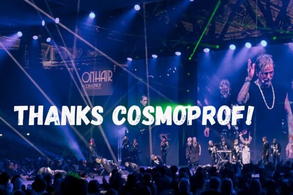 Spettacolo On Hair by Cosmoprof con parrucchieri sul palco e luci blu scenografiche.