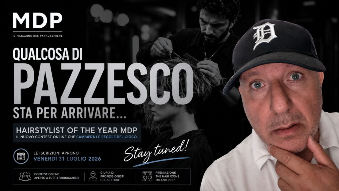 Anteprima del contest Hairstylist of the Year MDP con Alberto Montecroci in primo piano e la scritta "Qualcosa di pazzesco sta per arrivare". Sullo sfondo un hairstylist al lavoro e la data di apertura delle iscrizioni: 31 luglio 2026.