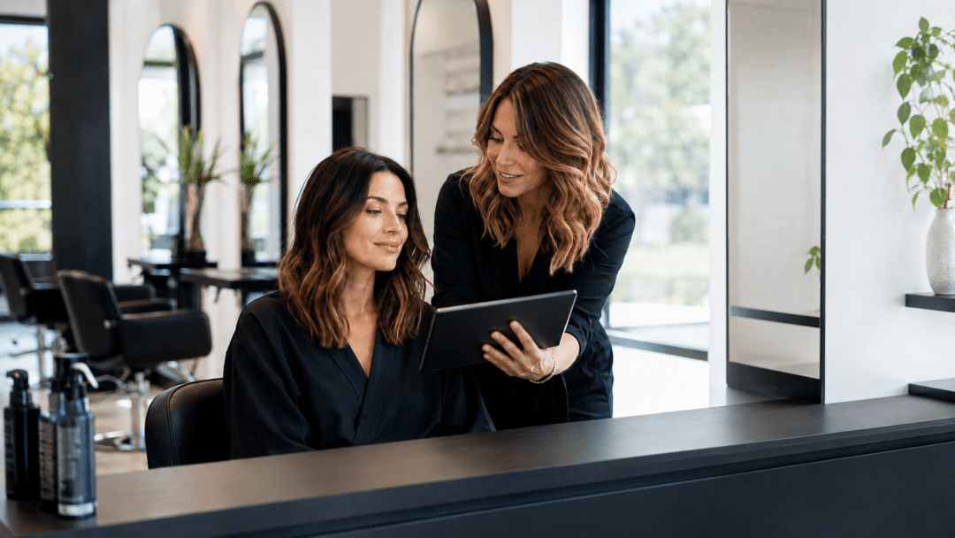 Hairstylist and client reviewing the desired result during a salon consultation