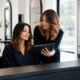 Hairstylist and client reviewing the desired result during a salon consultation