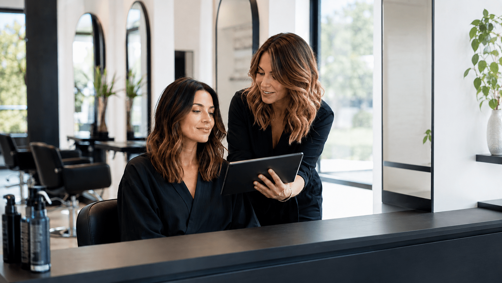 Hairstylist and client reviewing the desired result during a salon consultation