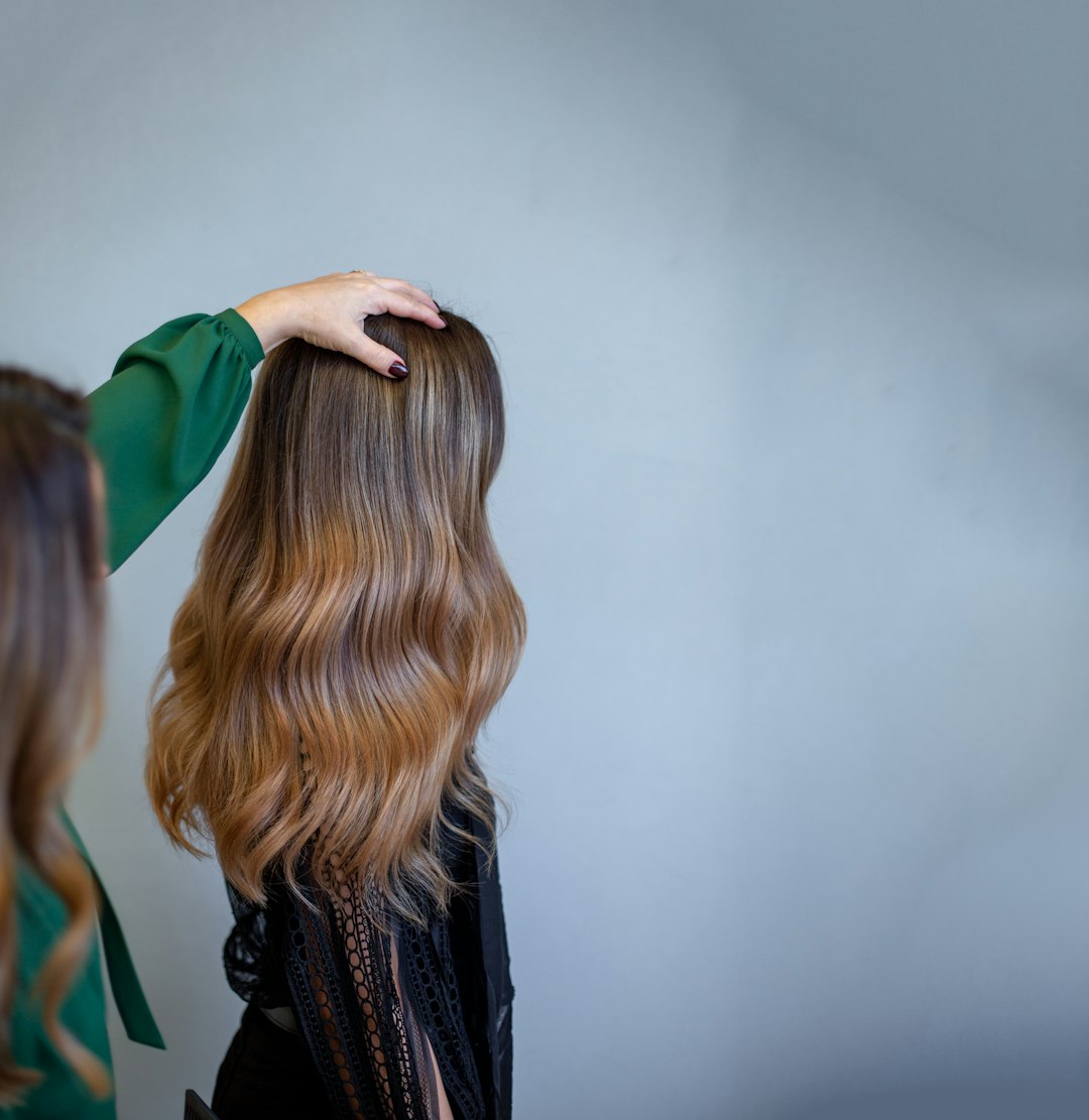 Close-up of long wavy coloured hair during a salon consultation