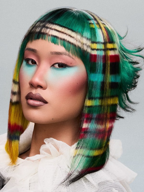 Primo piano di caschetto verde con fasce multicolori ispirate al tartan