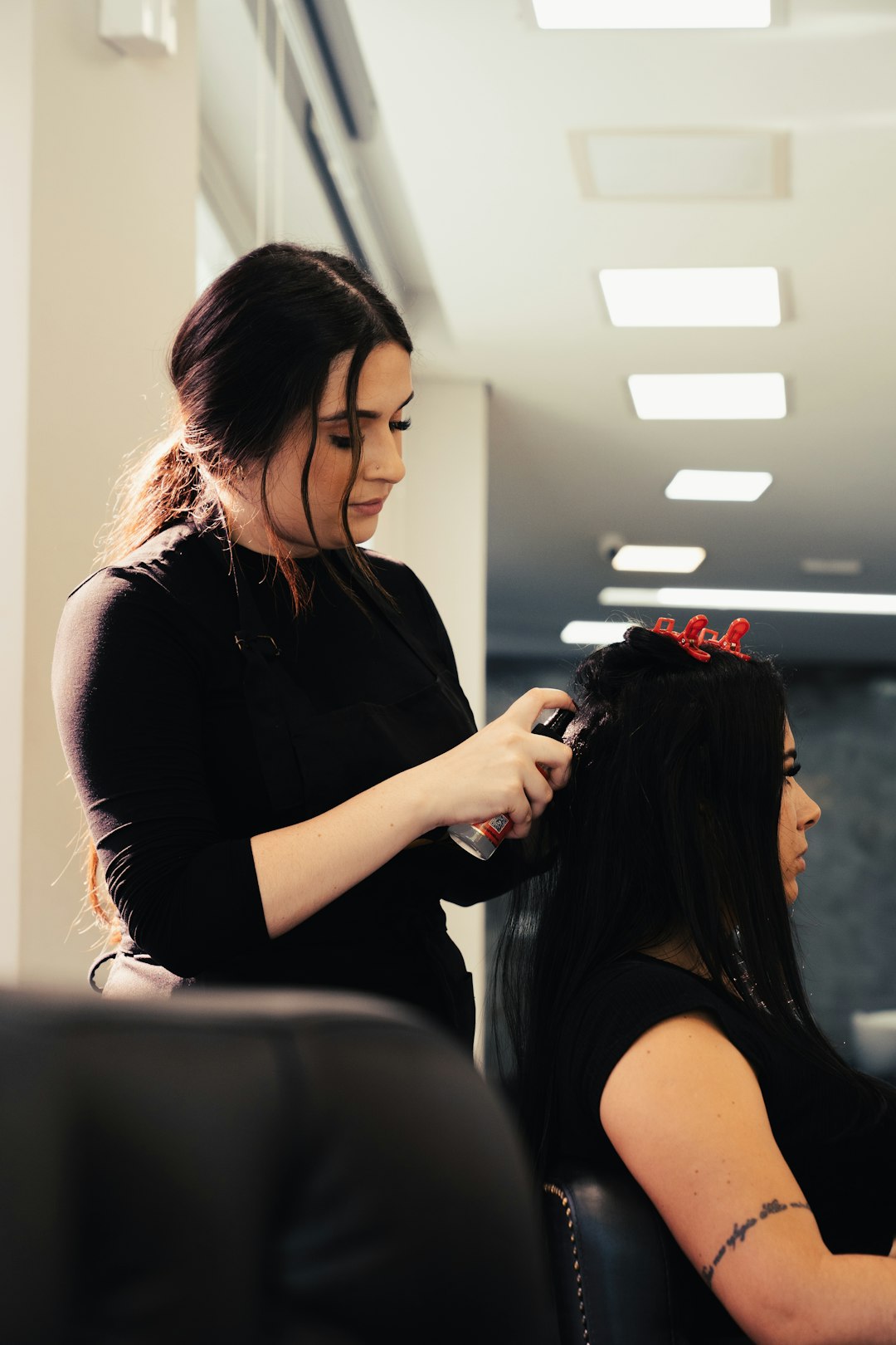 Professional hairstylist working on a client in a salon