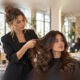 Hair stylist consulting a client with beautiful natural dark wavy hair, full faces and hairstyles visible