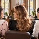 Autumn 2026 hair colour trends: three warm glossy shades in an Italian salon