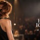 Logo THE HAIR ICONS Milano e modella con taglio d'autore sul palco